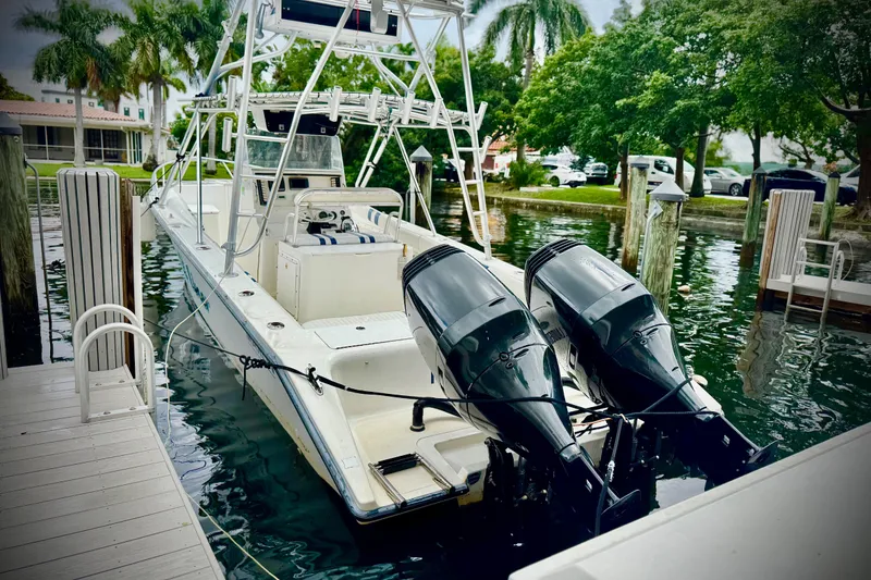 Slide: The Image of 1993 Marlin 35 CC Sportfish with Cuddy, docked, featuring dual outboard motors. - 4