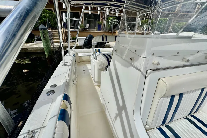 Slide: The Image of 1993 Marlin 35 CC Sportfish boat interior with striped seating and steering wheel. - 41