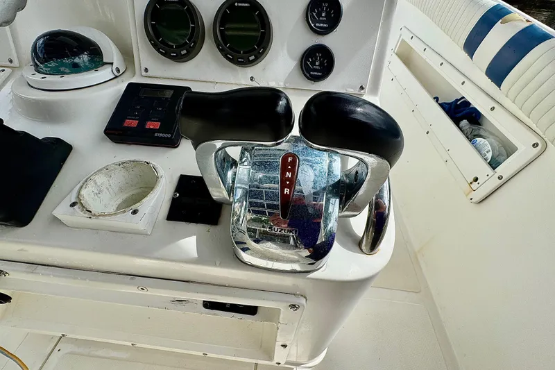 Slide: The Image of 1993 Marlin 35 CC Sportfish dashboard with Suzuki gauges and controls. - 53