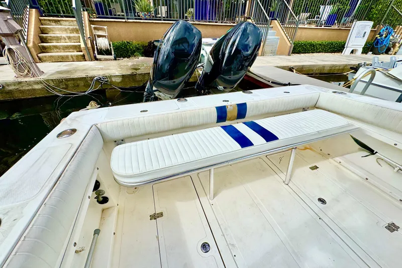 Slide: The Image of 1993 Marlin 35 CC Sportfish boat interior with cushioned seating and dual outboard motors. - 59