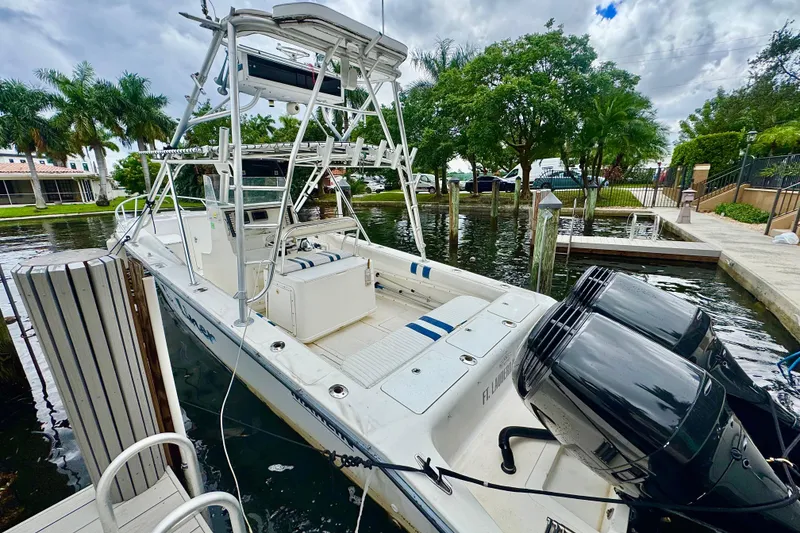Slide: The Image of Twin outboard motors on a 1993 Marlin 35 CC Sportfish boat docked. - 6