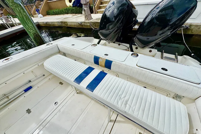 Slide: The Image of 1993 Marlin 35 CC Sportfish boat with dual engines docked near a residential area. - 60