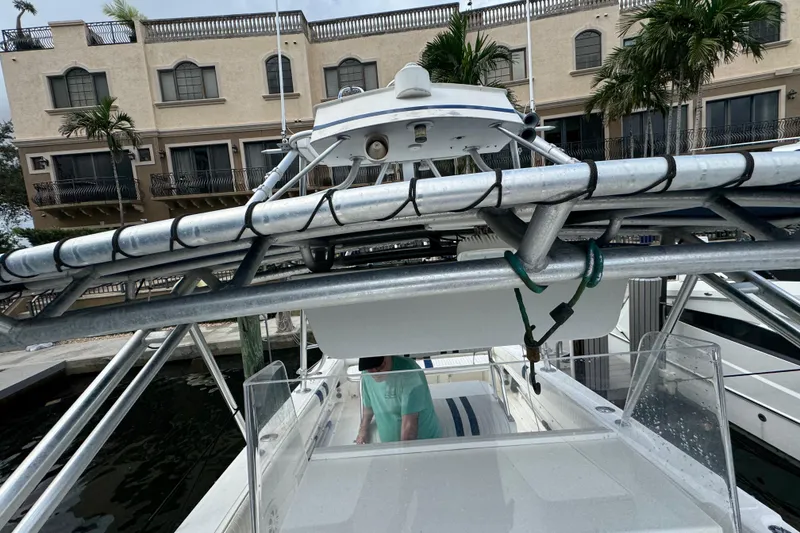 Slide: The Image of 1993 Marlin 35 CC Sportfish boat interior with open storage compartment and view of marina. - 63