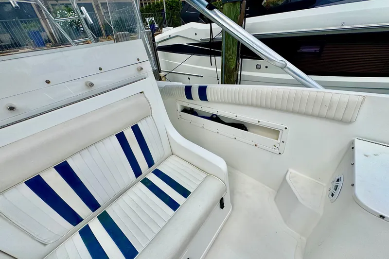 Slide: The Image of 1993 Marlin 35 CC Sportfish boat interior with open storage compartment and visible wiring. - 67