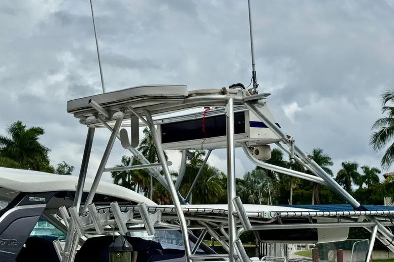 Slide: The Image of 1993 Marlin 35 CC Sportfish w/Cuddy docked, featuring dual outboard motors and tropical backdrop. - 75