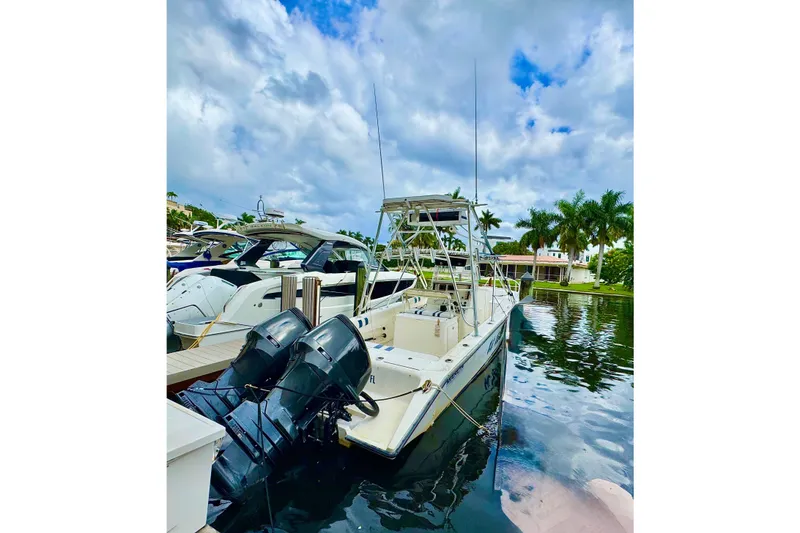 Slide: The Image of 1993 Marlin 35 CC Sportfish boat with cuddy cabin, docked under cloudy skies. - 76
