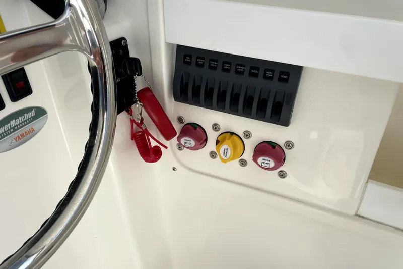 Slide: The Image of 2024 NorthCoast 235 boat dashboard with steering wheel and control panel. - 11