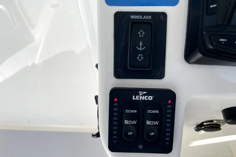 Slide: The Image of Control panel of 2024 NorthCoast 235 boat featuring windlass and Lenco trim tab switches. - 12