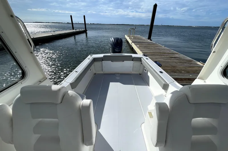 Slide: The Image of 2024 NorthCoast 235 boat interior with dock and water view. - 19