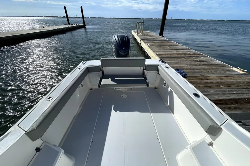 Slide: The Image of 2024 NorthCoast 235 boat docked by a wooden pier on a sunny day. - 20