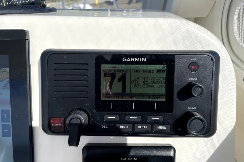 Slide: The Image of Garmin marine radio on 2024 NorthCoast 235 boat dashboard, displaying coordinates and time. - 27