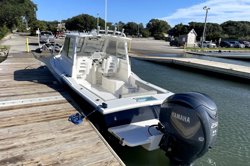 Slide: The Image of 2024 NorthCoast 235 boat docked with Yamaha 250 V6 engine, sunny day. - 5