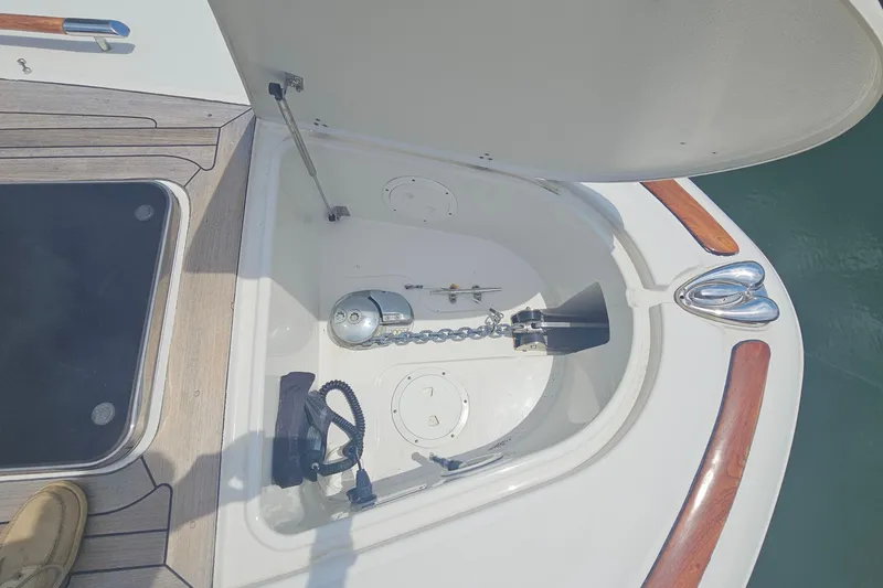 Slide: The Image of 2006 Chris-Craft Corsair 36 anchor compartment with chain and winch. - 16