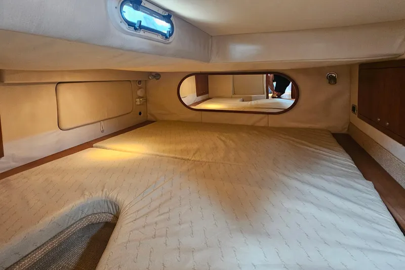 Slide: The Image of Interior cabin of 2006 Chris-Craft Corsair 36 with beige upholstery and wooden accents. - 24
