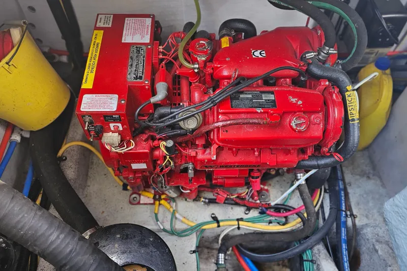 Slide: The Image of Engine compartment of a 2006 Chris-Craft Corsair 36, featuring a red marine engine. - 30