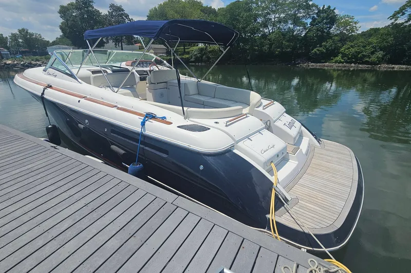 Slide: The Image of 2006 Chris-Craft Corsair 36 boat docked on a sunny day, featuring sleek design and canopy. - 4