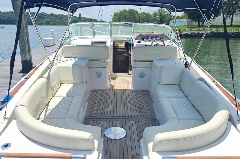 Slide: The Image of 2006 Chris-Craft Corsair 36 boat interior with luxurious seating and wooden deck. - 8