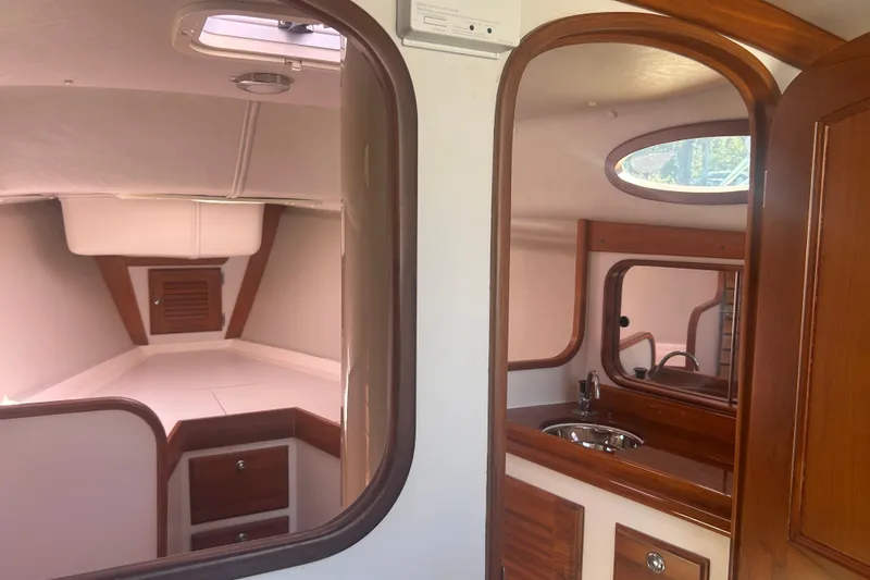 Slide: The Image of Interior of 2008 Alerion Express 33 sailboat with wood accents and compact sink area. - 15