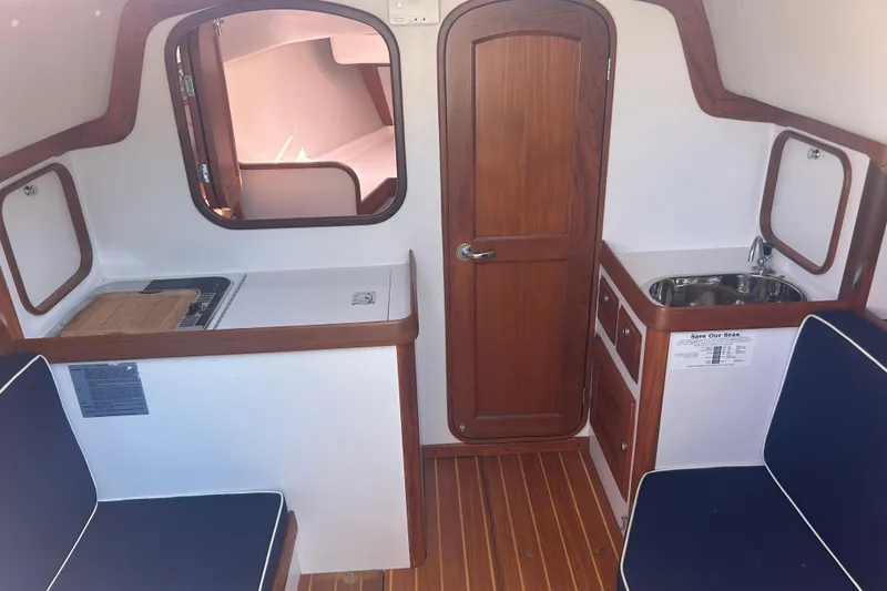 Slide: The Image of Interior of 2008 Alerion Express 33 sailboat with wood finishes and compact kitchenette. - 16