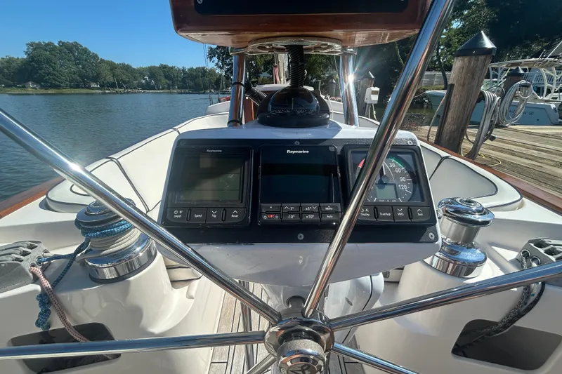 Slide: The Image of 2008 Alerion Express 33 sailboat cockpit with navigation instruments and steering wheel. - 19