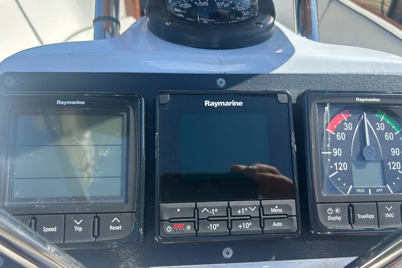 Slide: The Image of Cockpit instruments of a 2008 Alerion Express 33 sailboat, featuring Raymarine displays. - 20