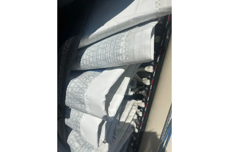 Slide: The Image of Rolled sails on a 2008 Alerion Express 33 sailboat, showcasing detailed stitching. - 21