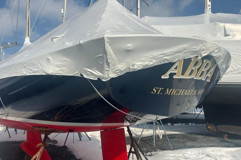 Slide: The Image of 2008 Alerion Express 33 sailboat, covered and docked, with "ABBA" and "St. Michaels, MD" on hull. - 22