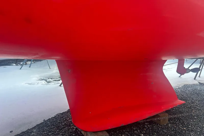 Slide: The Image of Red hull of 2008 Alerion Express 33 sailboat on snowy ground. - 24