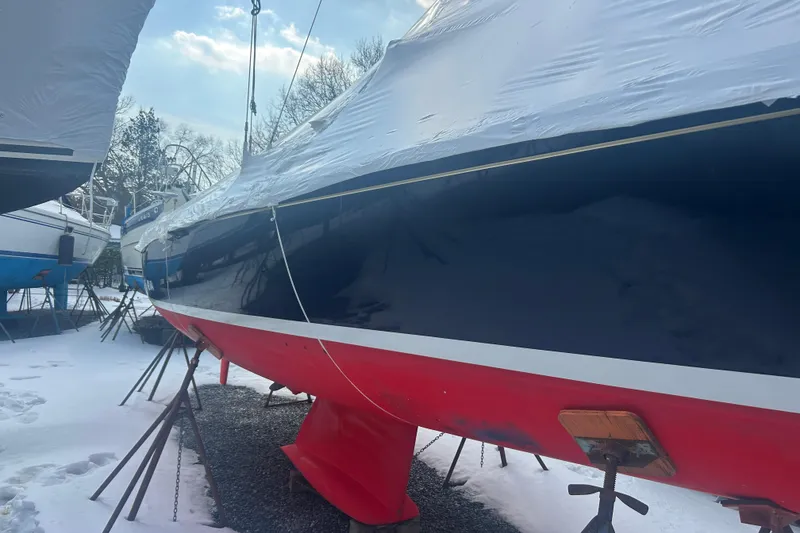 Slide: The Image of 2008 Alerion Express 33 sailboat in winter storage, covered and elevated on stands. - 25