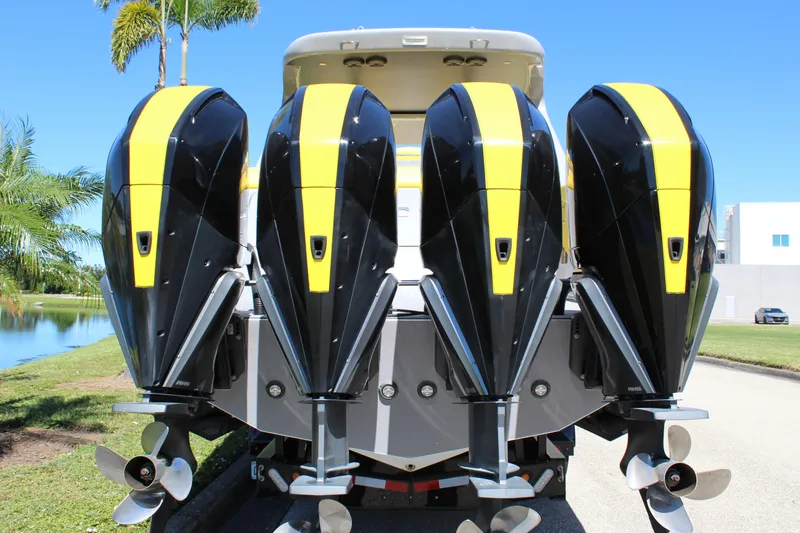 Slide: The Image of Four powerful outboard motors on a 2021 Mystic M4200 boat, featuring sleek black and yellow design. - 15