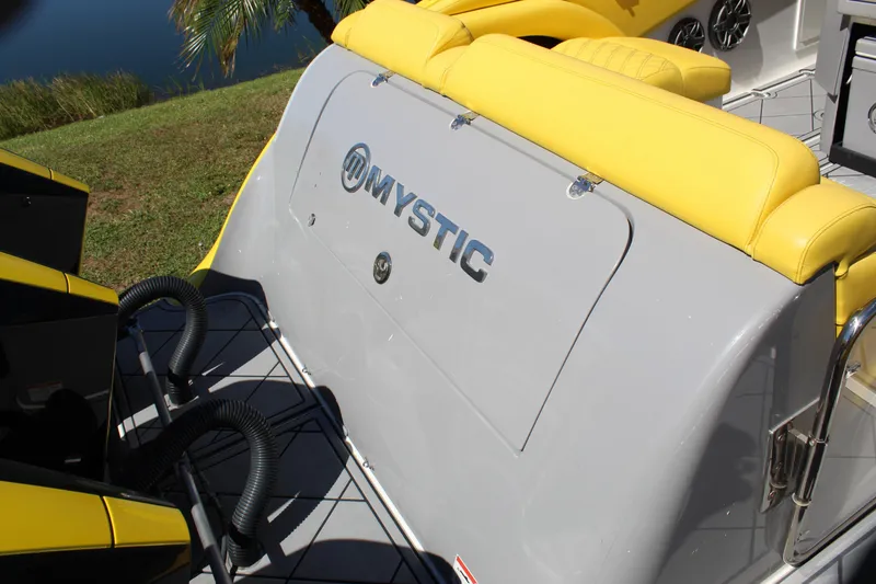 Slide: The Image of 2021 Mystic M4200 boat with yellow seating and sleek design. - 18
