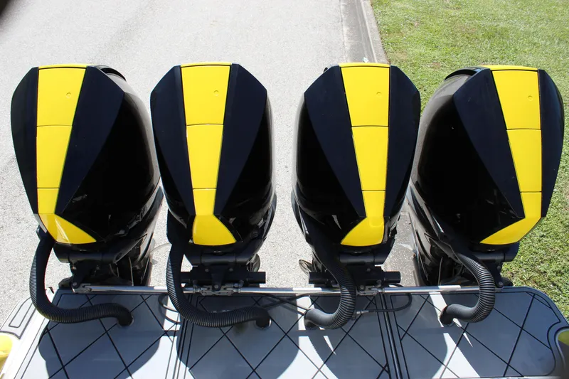 Slide: The Image of Four black and yellow outboard motors on a Mystic M4200, 2021 model. - 19
