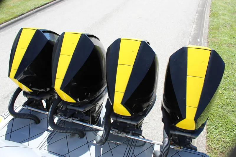 Slide: The Image of Four black and yellow outboard motors on a 2021 Mystic M4200 boat. - 21