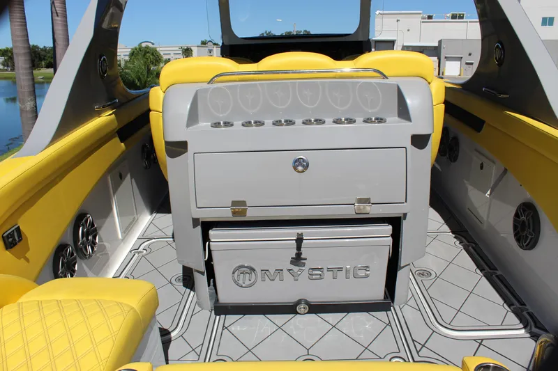 Slide: The Image of Interior of 2021 Mystic M4200 boat with yellow seating and storage compartments. - 22