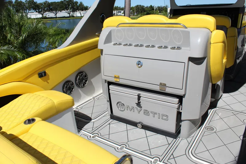 Slide: The Image of Yellow and gray interior of 2021 Mystic M4200 boat with seating and storage. - 23