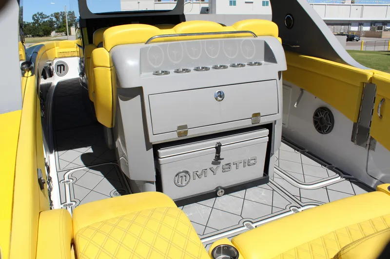 Slide: The Image of Yellow interior of 2021 Mystic M4200 boat with seating and storage. - 24