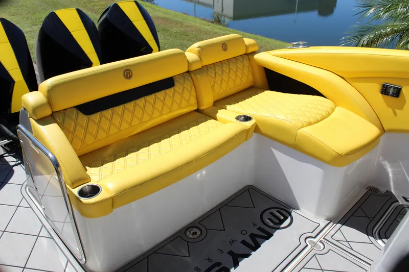 Slide: The Image of Yellow seating on 2021 Mystic M4200 boat with quilted design and cup holders. - 28