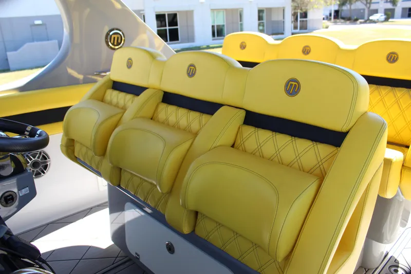 Slide: The Image of Yellow leather seats in a 2021 Mystic M4200 boat interior. - 33