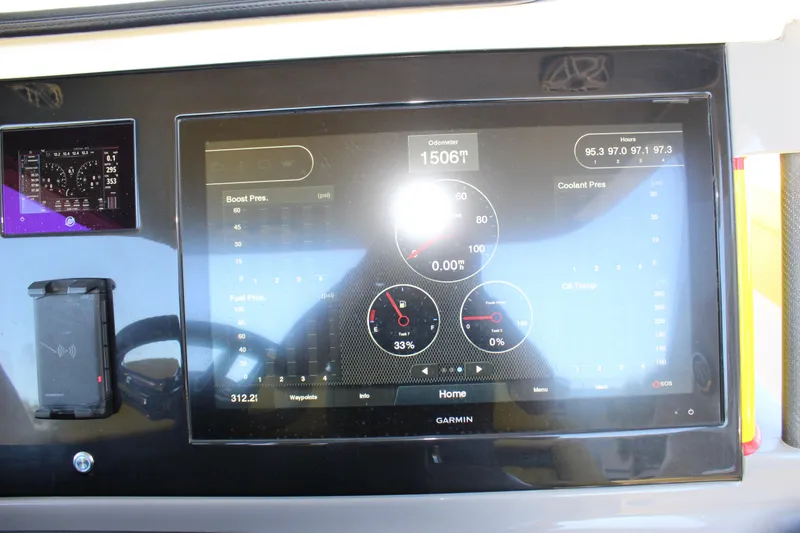 Slide: The Image of Dashboard of a 2021 Mystic M4200 boat displaying engine metrics on a Garmin screen. - 40