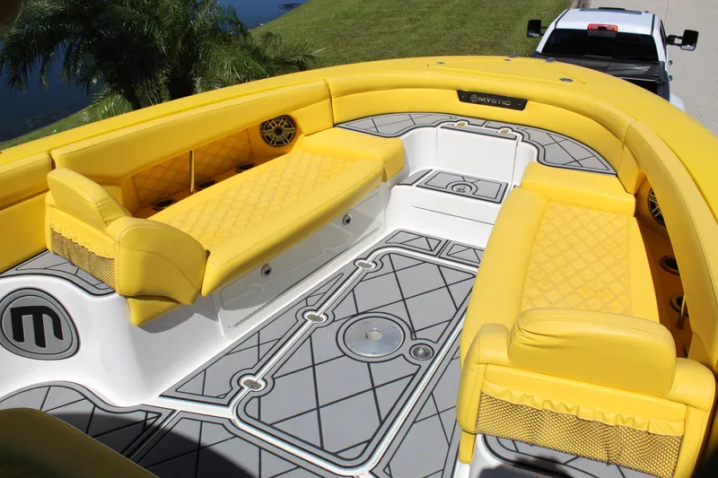 Slide: The Image of Yellow interior of 2021 Mystic M4200 boat with quilted seating and geometric flooring. - 45