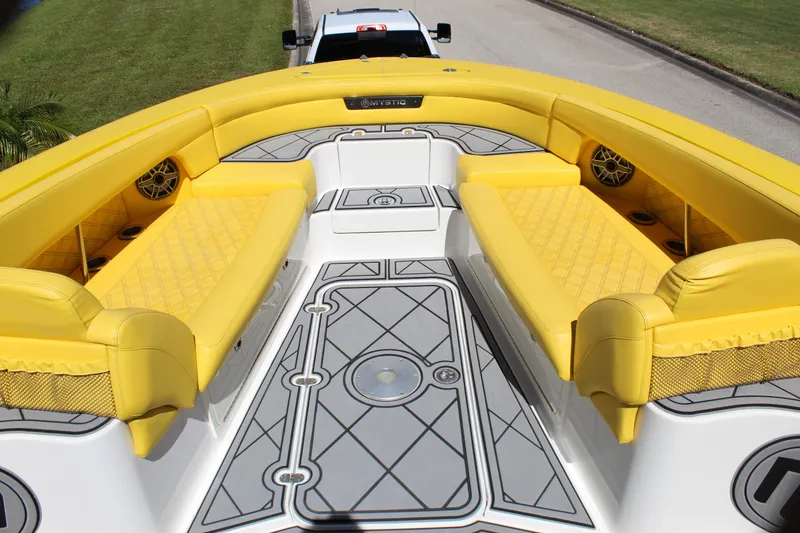 Slide: The Image of Yellow seating on 2021 Mystic M4200 boat deck, featuring stylish design and speaker system. - 46