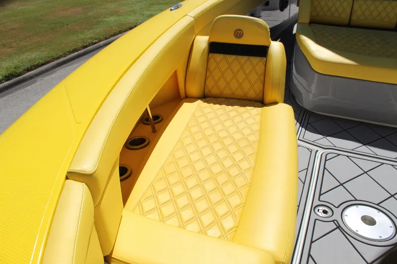 Slide: The Image of Yellow quilted seating on 2021 Mystic M4200 boat, featuring stylish design and cup holders. - 49