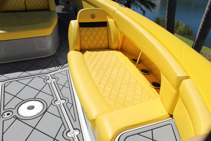 Slide: The Image of Yellow seating on 2021 Mystic M4200 boat with quilted design and cup holders. - 50