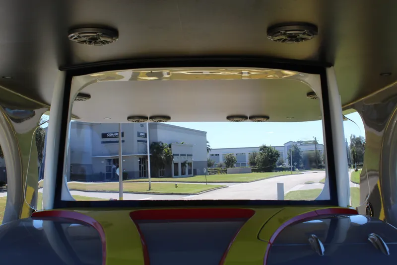 Slide: The Image of Interior view of 2021 Mystic M4200 boat with street and buildings visible outside. - 54