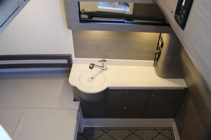 Slide: The Image of Modern bathroom interior in 2021 Mystic M4200 yacht, featuring sleek sink and cabinetry. - 55