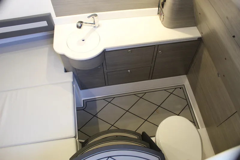 Slide: The Image of Modern bathroom interior in 2021 Mystic M4200 boat, featuring sleek cabinetry and compact design. - 57