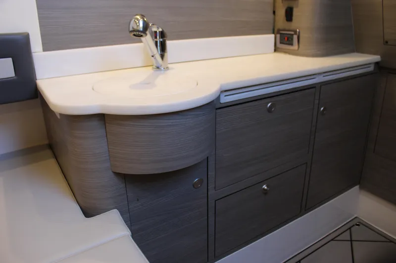 Slide: The Image of Modern bathroom vanity in Mystic M4200, 2021 model, featuring sleek cabinetry and chrome faucet. - 58