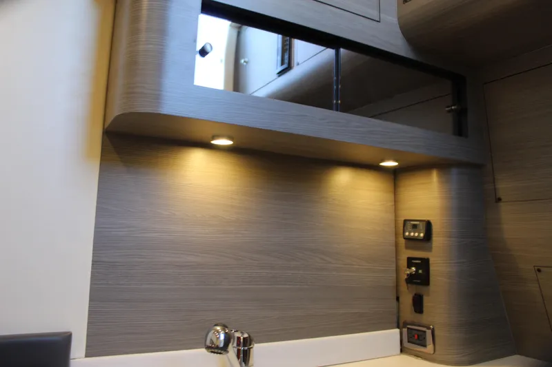 Slide: The Image of Modern interior of Mystic M4200 yacht, 2021 model, featuring sleek wood paneling and ambient lighting. - 59