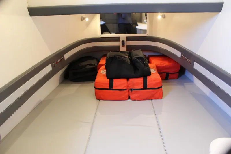 Slide: The Image of Interior cabin of 2021 Mystic M4200 with orange and black bags on the floor. - 63