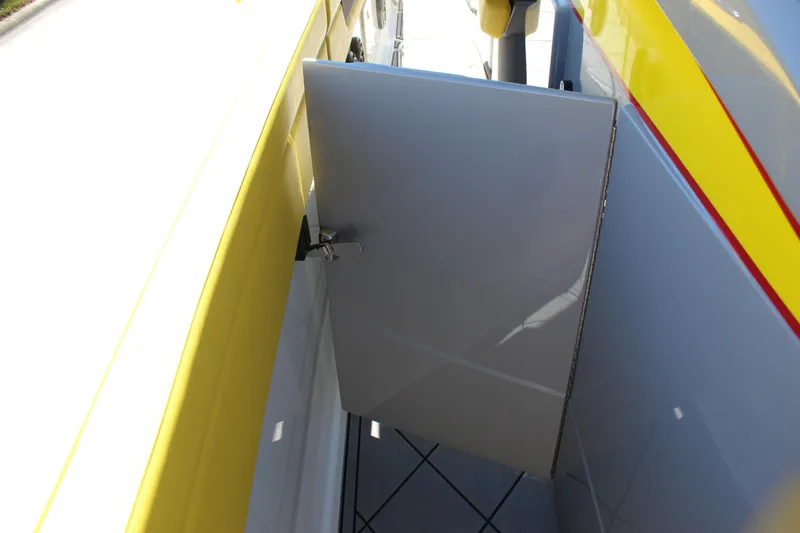 Slide: The Image of 2021 Mystic M4200 boat with open side compartment, yellow and gray exterior. - 65